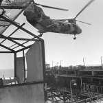 A Marine Utility/Attack Helicopter Squadron 167 (HML/A-167) CH-46E Sea Knight helicopter prepares to transport confiscated military equipment from an Iranian oil platform. The platform was strafed a later destroyed by gunfire from U.S. destroyers.