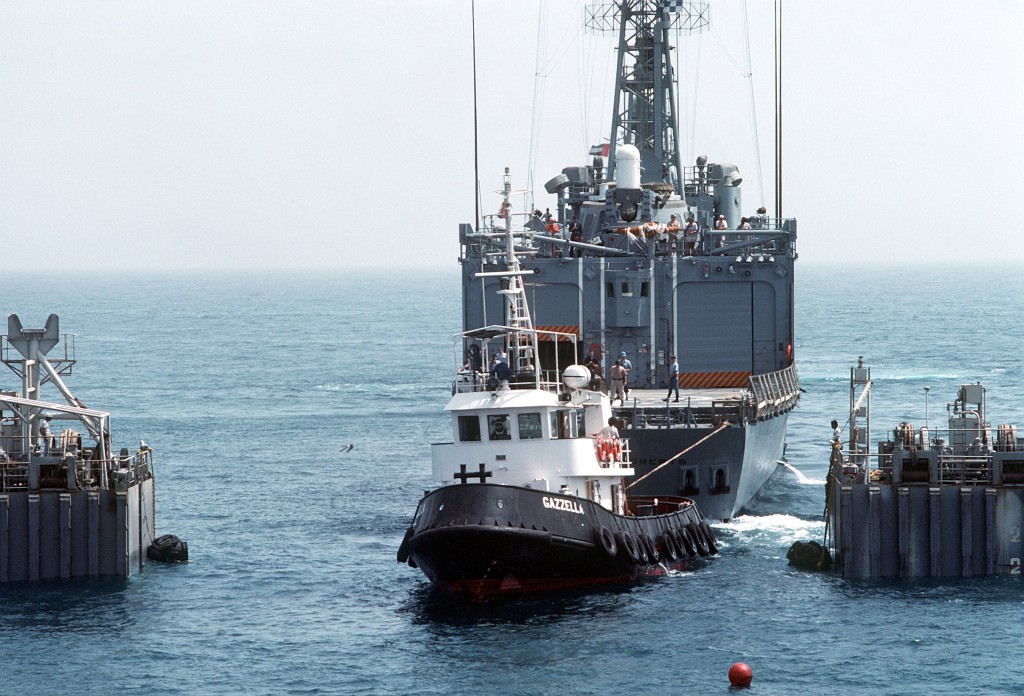 A tug pulls <i>Roberts</i> into position over MS2's cargo deck. Because of tolerances measures in inches, the loading will take some 12 hours. (U.S. Navy photo by PH2 Michael Harnar)
