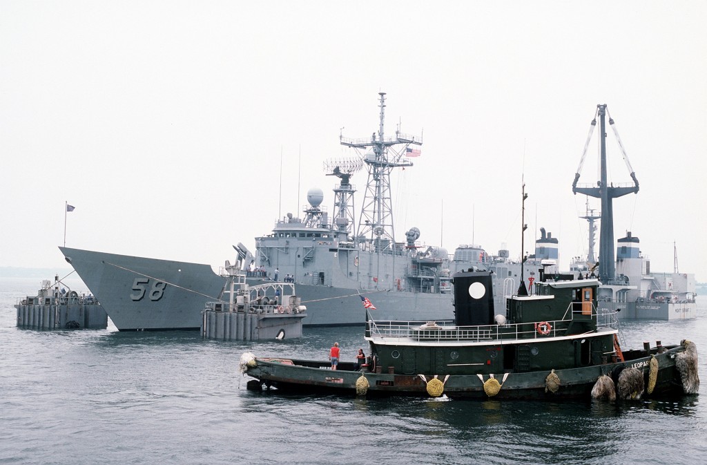 The Dutch salvage ship MIGHTY SERVANT II prepares to lift the guided missile frigate USS SAMUEL B. ROBERTS (FFG-58) onto its deck for transport back to its home port in Newport, R.I. The frigate was damaged after it struck a mine in the Persian Gulf on 14 April 1988.