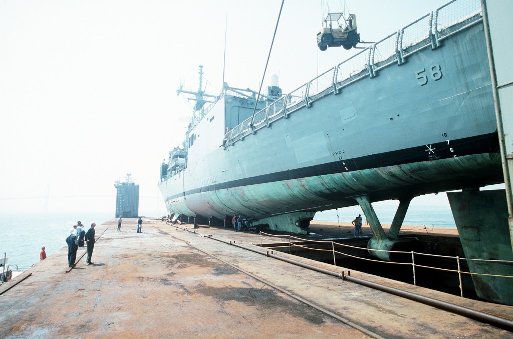 A port quarter view of the guided missile frigate USS SAMUEL B. ROBERTS (FFG-58) secured on the deck of the Dutch salvage ship MIGHTY SERVANT II. The MIGHTY SERVANT II is transporting the frigate back to its home port in Newport, R.I., after it struck a mine in the Persian Gulf on 14 April 1988.